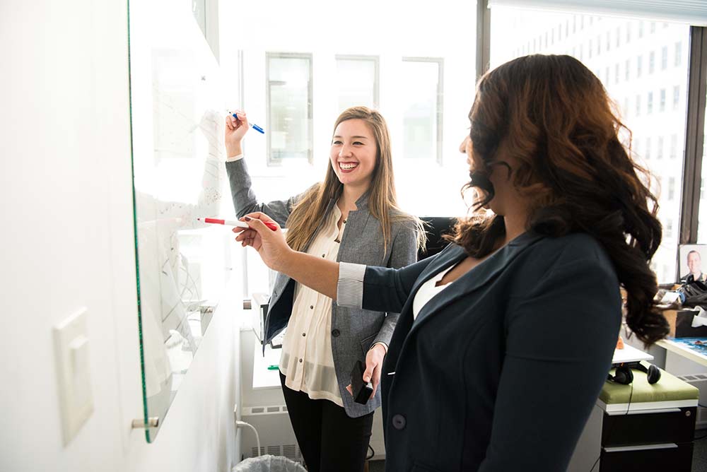 colleagues writing on whiteboard