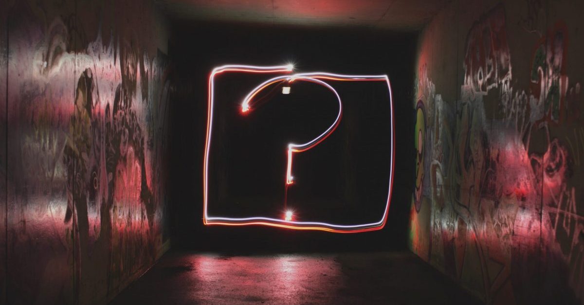 image description: neon questionmark on a black background