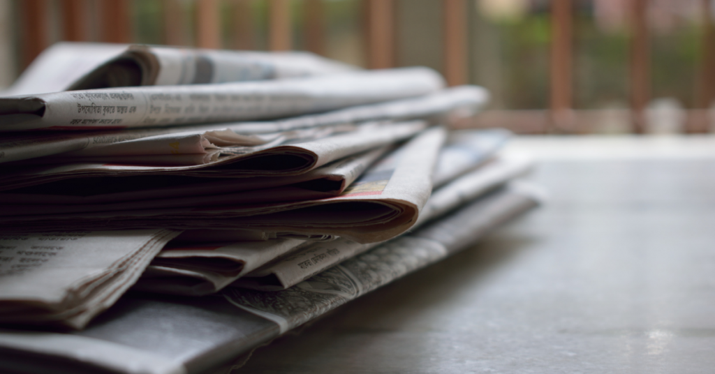 image shows a pile of newspapers